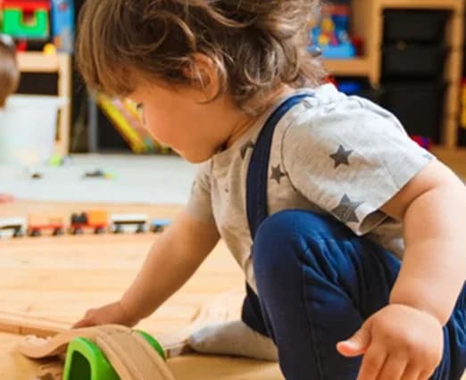 Child playing with toys on the floor